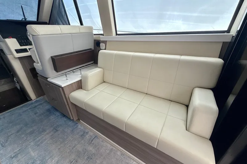  Yacht Photos Pics 2022 Regal 38 XO yacht interior with beige leather seating and modern design.