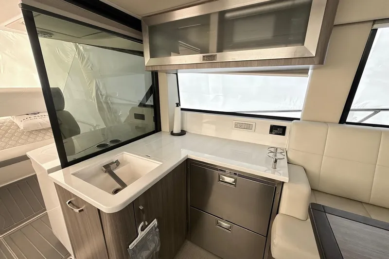  Yacht Photos Pics Modern kitchen area in 2022 Regal 38 XO yacht with sleek cabinetry and appliances.