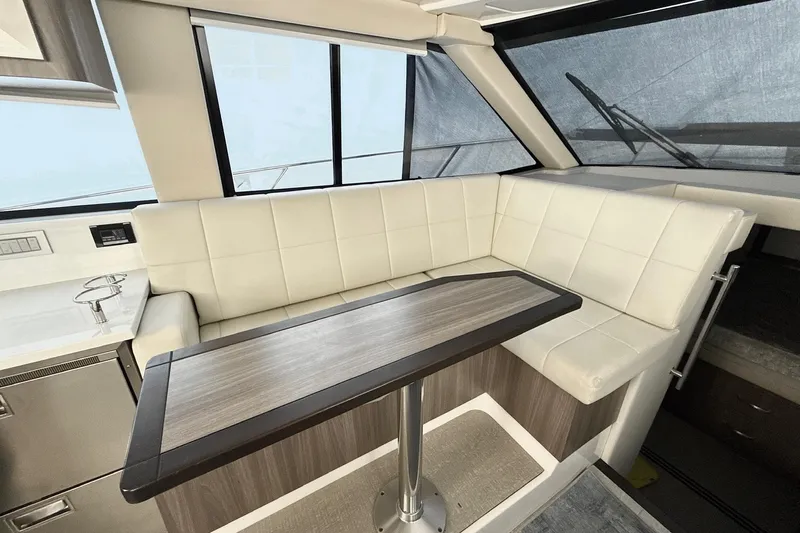  Yacht Photos Pics Luxurious interior of 2022 Regal 38 XO yacht with white seating and wooden table.
