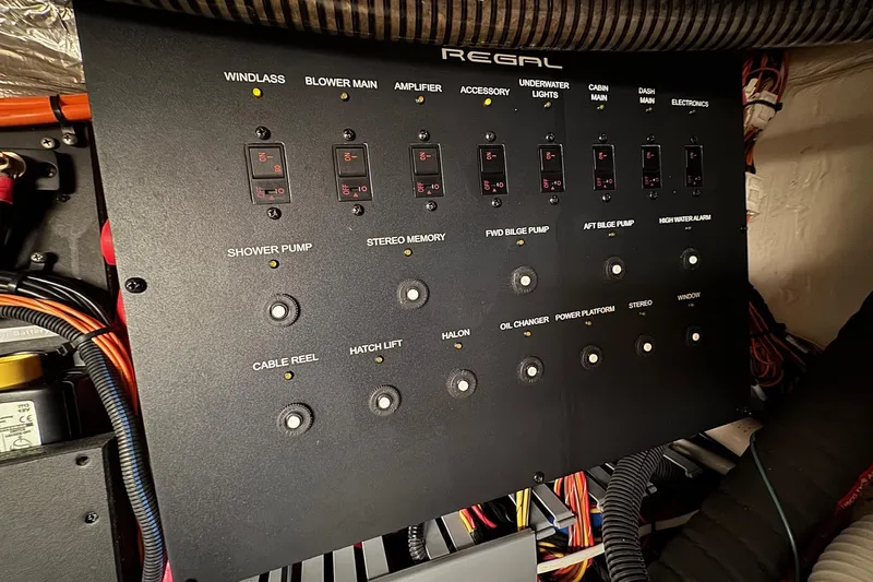  Yacht Photos Pics Electrical control panel of a 2022 Regal 38 XO boat with labeled switches and wiring.