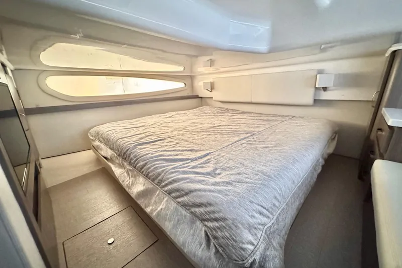  Yacht Photos Pics 2022 Regal 38 XO yacht interior cabin with a comfortable bed and modern design.