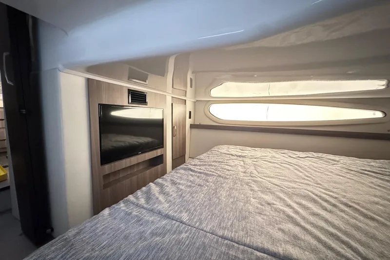  Yacht Photos Pics Interior of 2022 Regal 38 XO yacht with bed and wall-mounted TV.