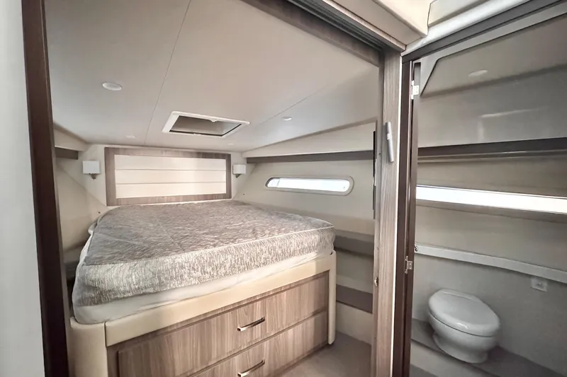  Yacht Photos Pics Luxurious 2022 Regal 38 XO yacht interior with cozy bed and modern bathroom.