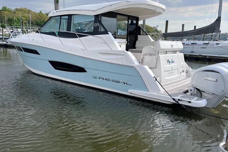  Yacht Photos Pics 2022 Regal 38 XO yacht docked, featuring sleek design and Yamaha outboard engines.