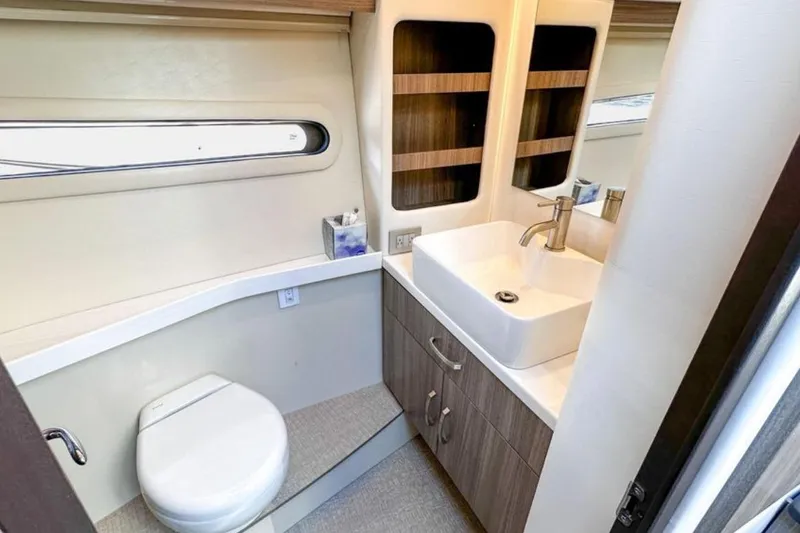  Yacht Photos Pics Luxurious bathroom in 2022 Regal 38 XO yacht with modern sink and toilet.