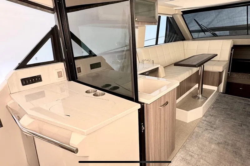  Yacht Photos Pics Interior of 2022 Regal 38 XO yacht with modern kitchen and seating area.