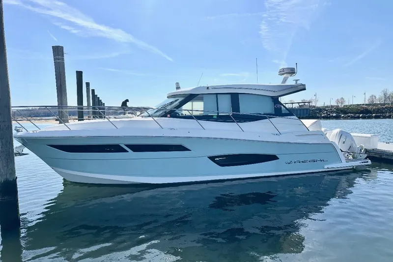  Yacht Photos Pics 2022 Regal 38 XO yacht docked in a marina under clear blue skies.