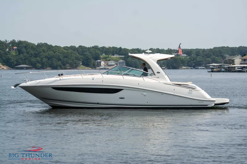  Yacht Photos Pics 2016 Sea Ray 370 Sundancer yacht on a serene lake, side view.