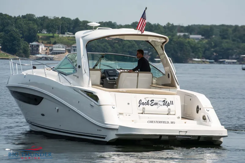  Yacht Photos Pics 2016 Sea Ray 370 Sundancer cruising on a lake with an American flag.