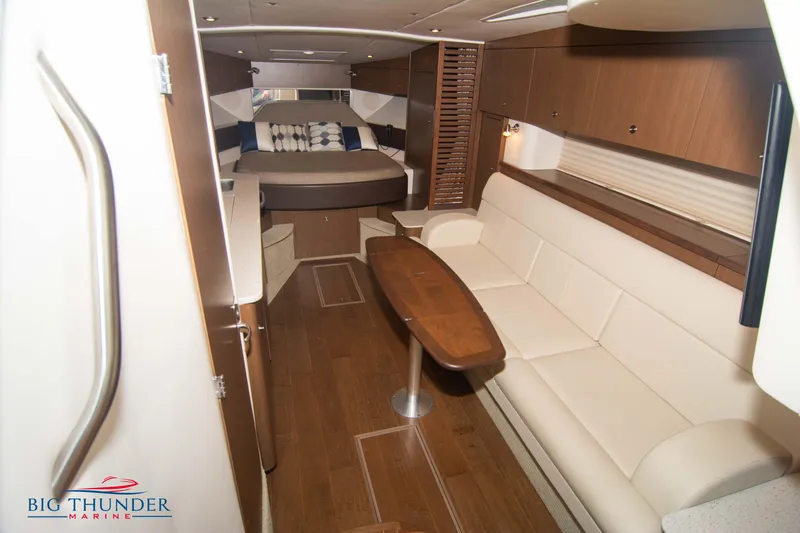  Yacht Photos Pics Luxurious interior of 2016 Sea Ray 370 Sundancer yacht with elegant seating and wood finishes.