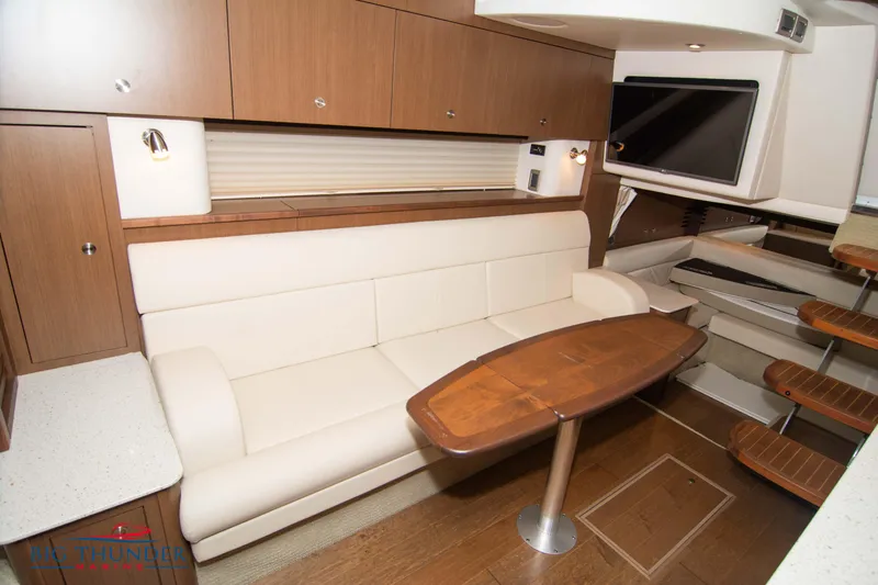  Yacht Photos Pics Interior of 2016 Sea Ray 370 Sundancer with modern seating and wooden table.