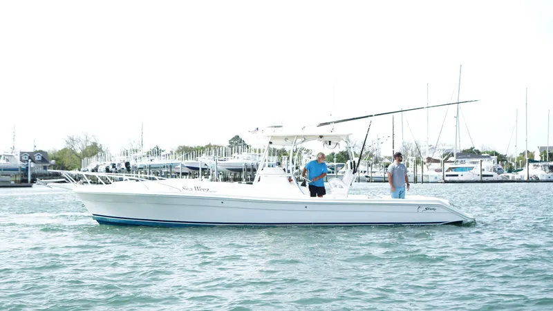  Yacht Photos Pics A 2016 Strike 35 boat on water with two people onboard, near a marina.