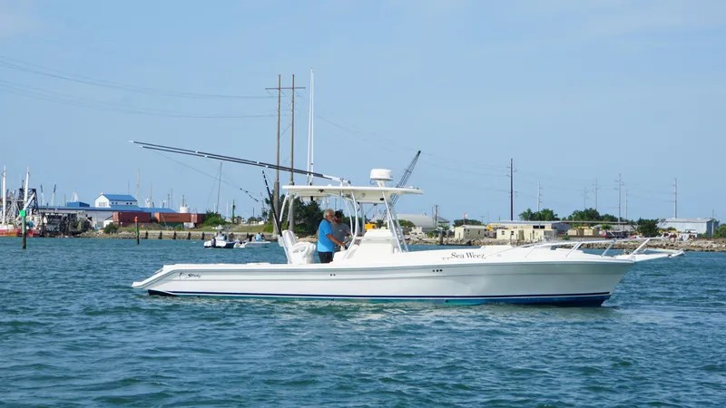  Yacht Photos Pics 2016 Strike 35 boat cruising on calm waters near a coastal town.