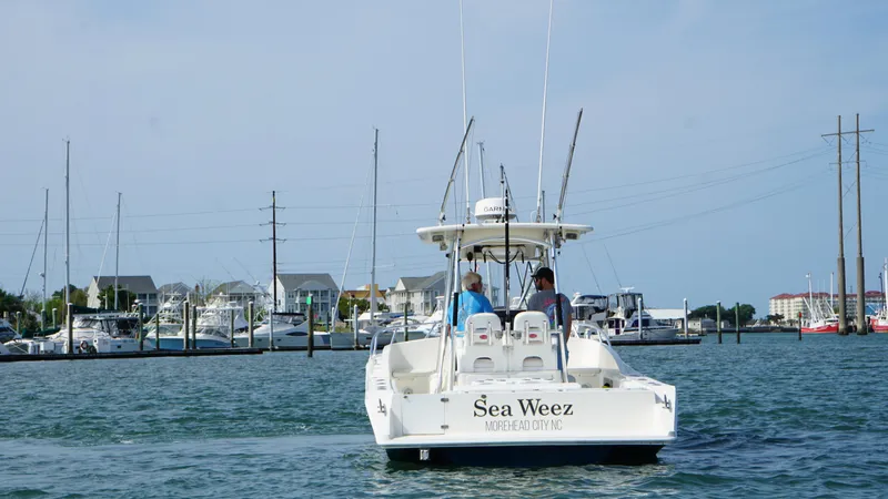  Yacht Photos Pics Boat named "Sea Weez" on water, Strike 35 model, 2016, near marina with docks and buildings.