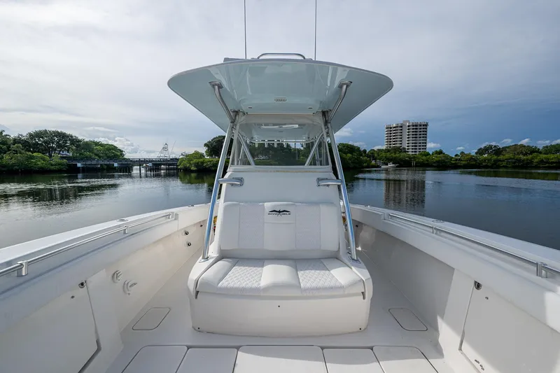  Yacht Photos Pics 2016 Invincible 39 Open Fisherman boat on calm water, featuring spacious seating and sleek design.