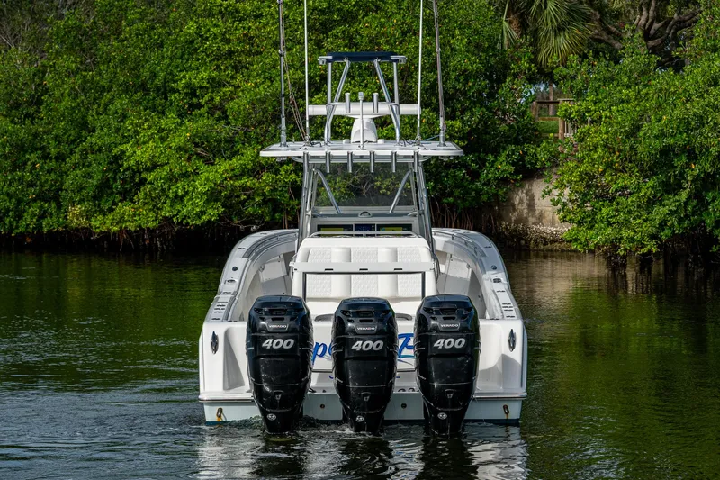  Yacht Photos Pics 2016 Invincible 39 Open Fisherman boat with triple 400 horsepower engines on a calm waterway.