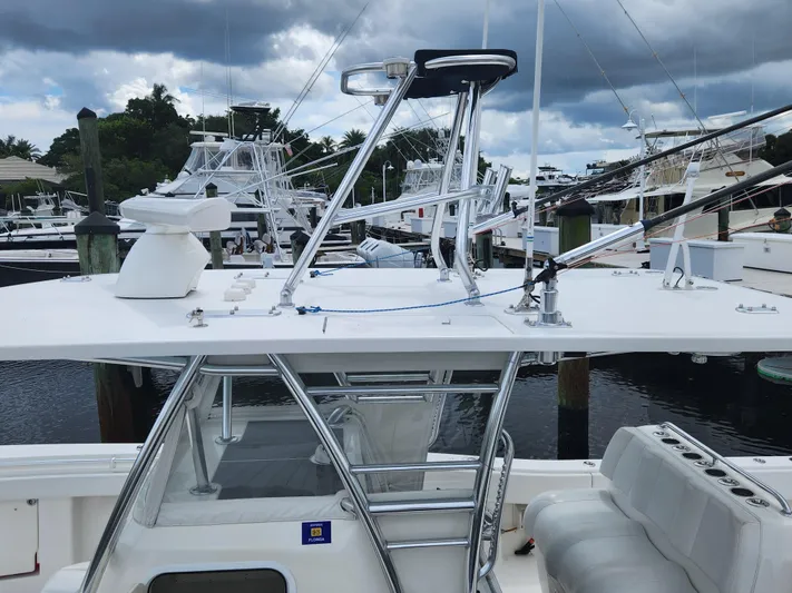  Yacht Photos Pics 2016 Invincible 39 Open Fisherman boat docked at marina under cloudy sky.