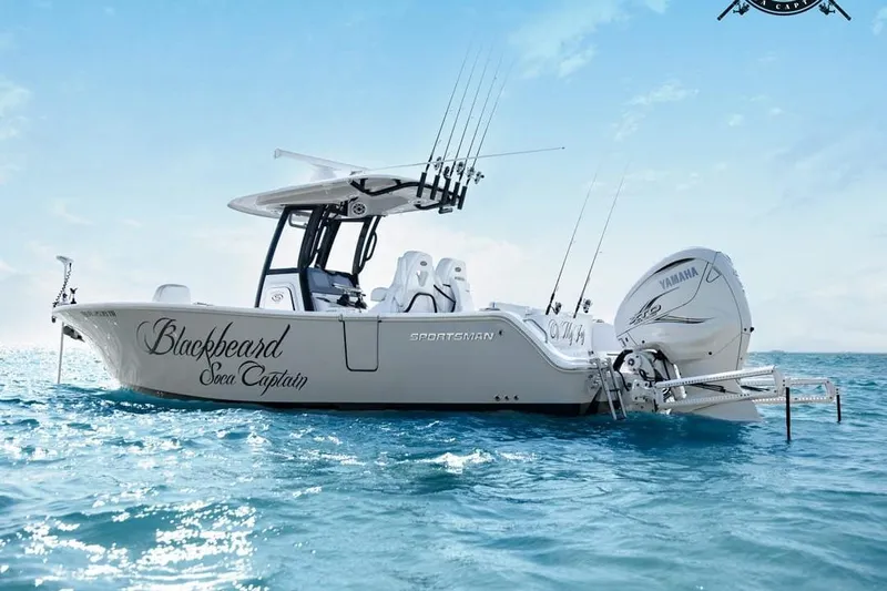  Yacht Photos Pics 2023 Sportsman Heritage 261 Center Console boat on ocean, featuring fishing rods and Yamaha engine.