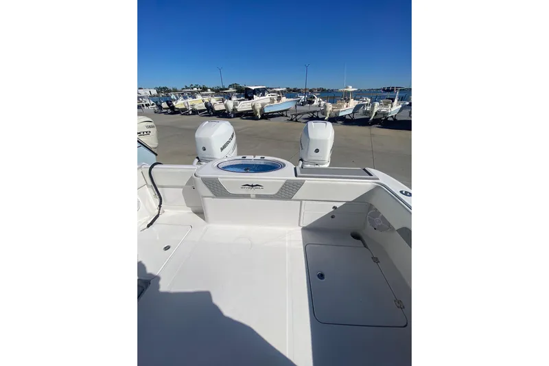  Yacht Photos Pics 2023 Invincible 33 Catamaran with dual Mercury engines, docked at a marina.