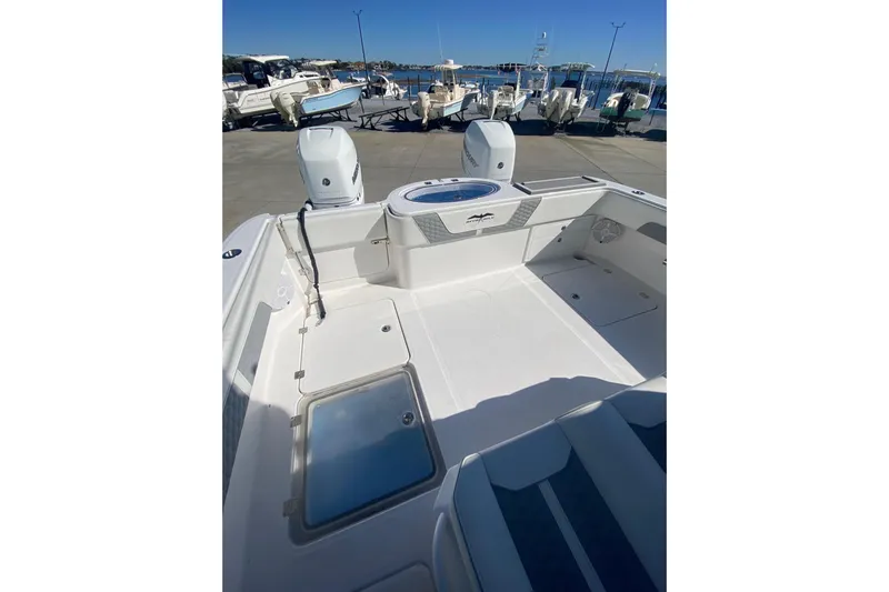  Yacht Photos Pics 2023 Invincible 33 Catamaran boat deck with twin engines, docked at marina.