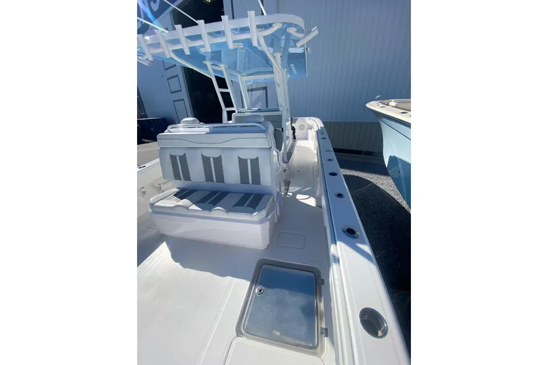  Yacht Photos Pics 2023 Invincible 33 Catamaran interior with seating and rod holders, showcasing sleek design.