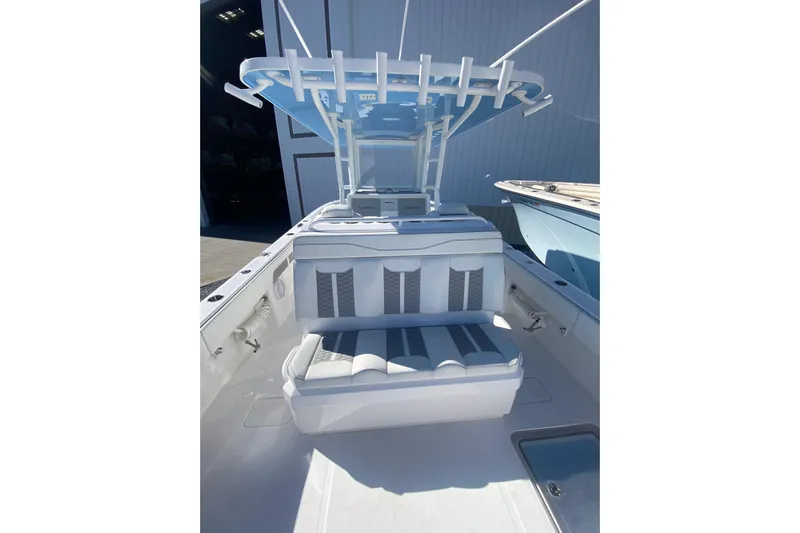  Yacht Photos Pics 2023 Invincible 33 Catamaran interior with cushioned seating and overhead rod holders.