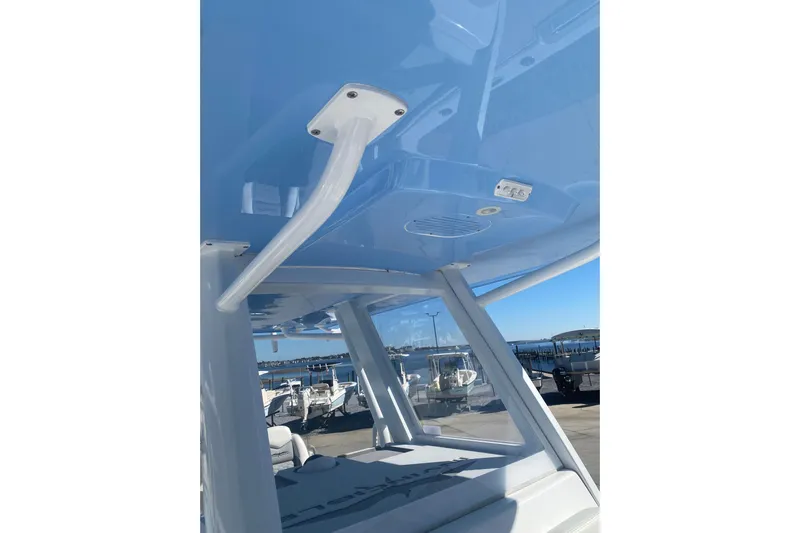  Yacht Photos Pics 2023 Invincible 33 Catamaran interior view with blue ceiling and marina background.