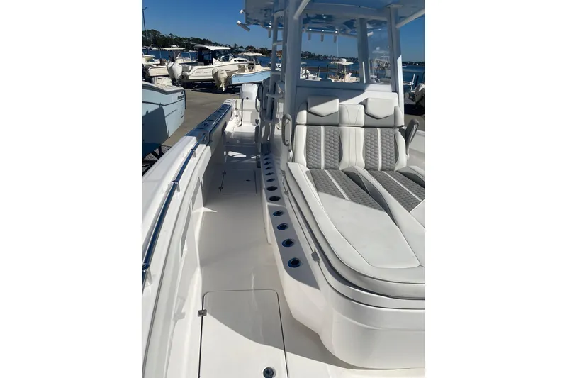  Yacht Photos Pics 2023 Invincible 33 Catamaran with sleek seating and modern design in a marina setting.