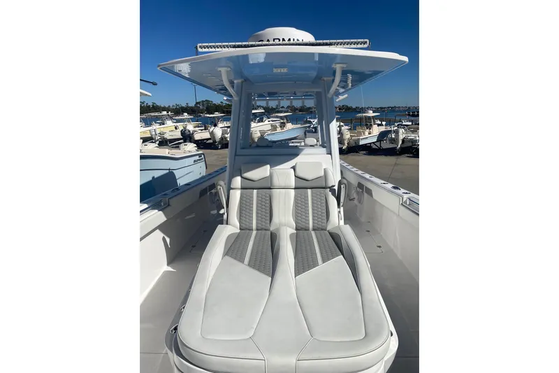  Yacht Photos Pics 2023 Invincible 33 Catamaran with sleek seating and modern design at a marina.