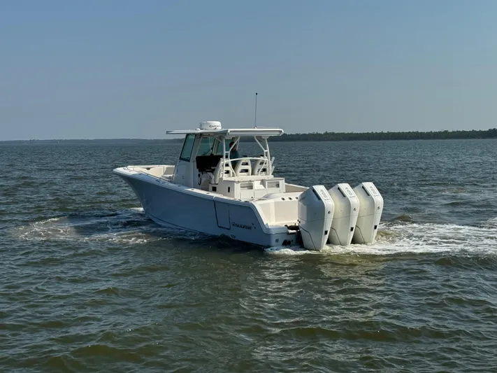  Yacht Photos Pics 2024 Sailfish 360 CC boat cruising on open water with triple engines.