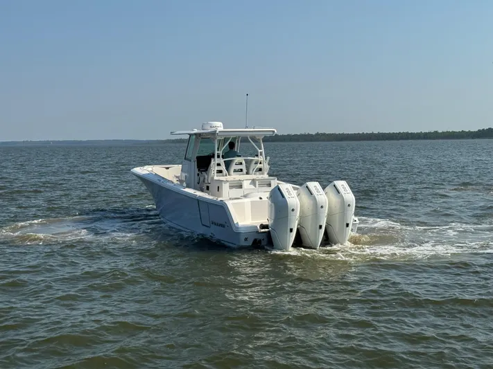  Yacht Photos Pics 2024 Sailfish 360 CC boat cruising on open water with triple engines.
