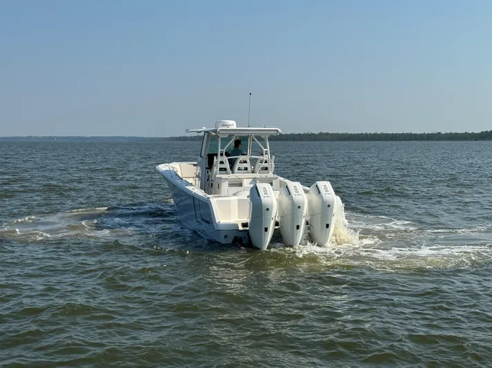  Yacht Photos Pics 2024 Sailfish 360 CC boat cruising on open water with triple engines.