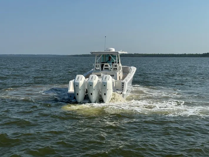  Yacht Photos Pics 2024 Sailfish 360 CC boat cruising on open water with triple engines.