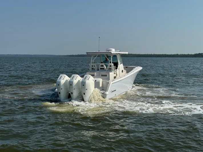  Yacht Photos Pics 2024 Sailfish 360 CC boat cruising on open water with triple engines.