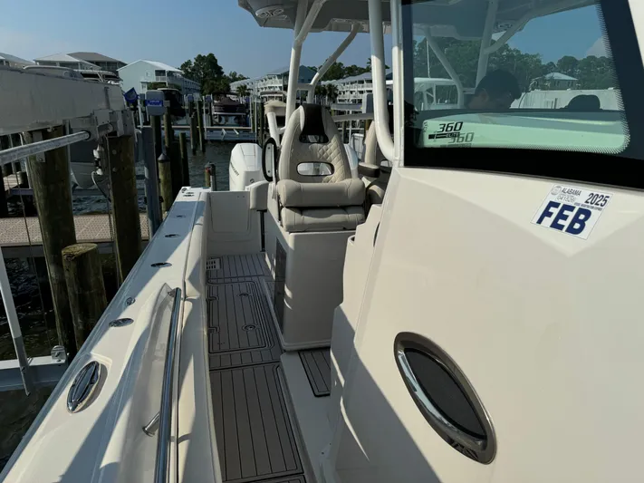  Yacht Photos Pics 2024 Sailfish 360 CC boat docked, featuring sleek design and comfortable seating.