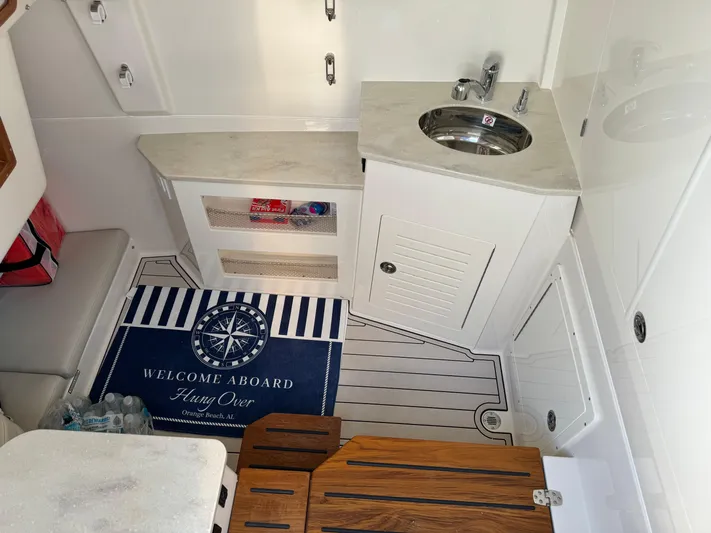  Yacht Photos Pics 2024 Sailfish 360 CC boat interior with sink, storage, and welcome mat.