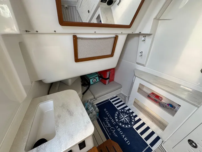  Yacht Photos Pics 2024 Sailfish 360 CC cabin interior with sink, storage, and welcome mat.