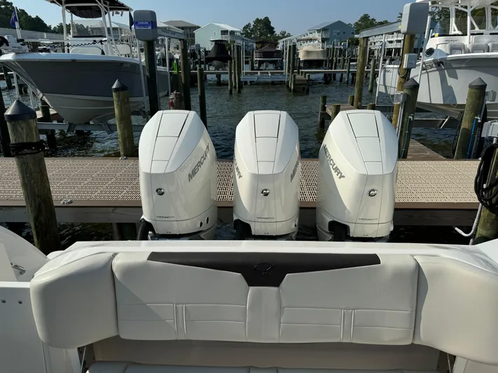  Yacht Photos Pics 2024 Sailfish 360 CC boat with triple Mercury outboard engines at a marina dock.