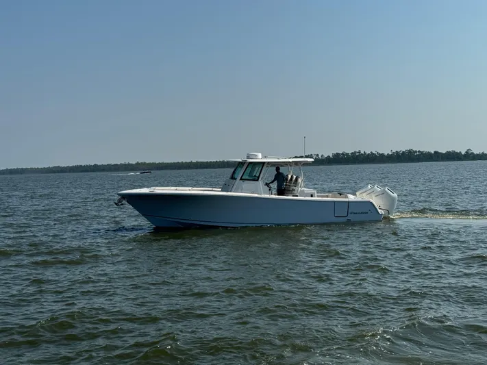  Yacht Photos Pics 2024 Sailfish 360 CC boat cruising on open water under clear skies.