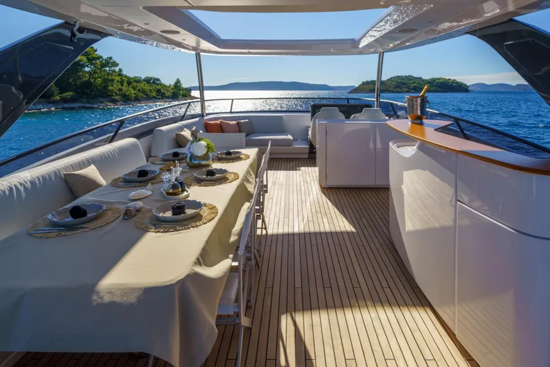  Yacht Photos Pics Luxurious 2025 Azimut Grande 26M yacht deck with elegant dining setup and ocean view.