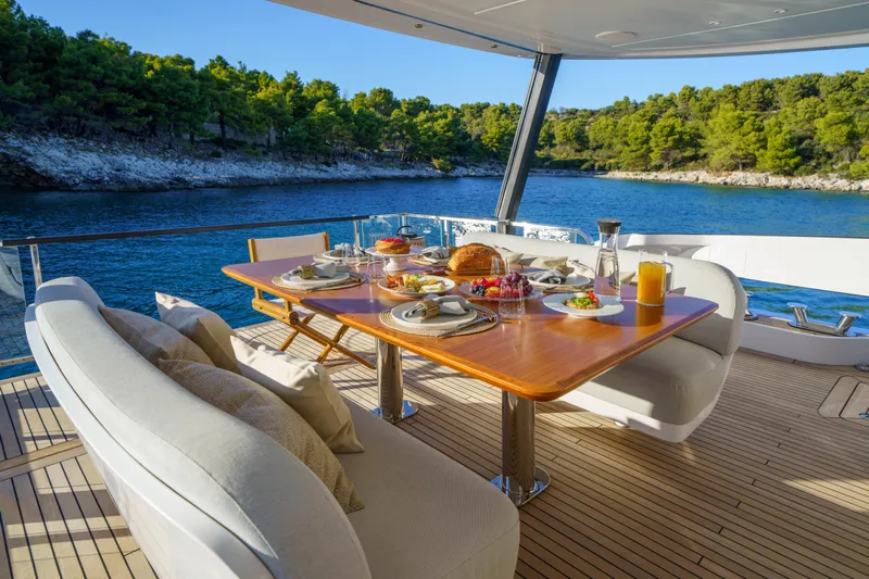  Yacht Photos Pics Luxury dining setup on Azimut Grande 26M yacht, 2025, with scenic ocean view.