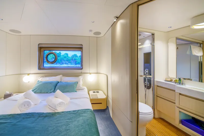  Yacht Photos Pics Luxurious bedroom and bathroom in 2025 Azimut Grande 26M yacht, featuring elegant design and comfort.