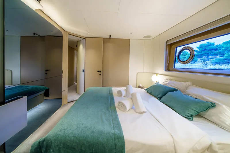  Yacht Photos Pics Luxurious bedroom interior of 2025 Azimut Grande 26M yacht with elegant decor and scenic window view.