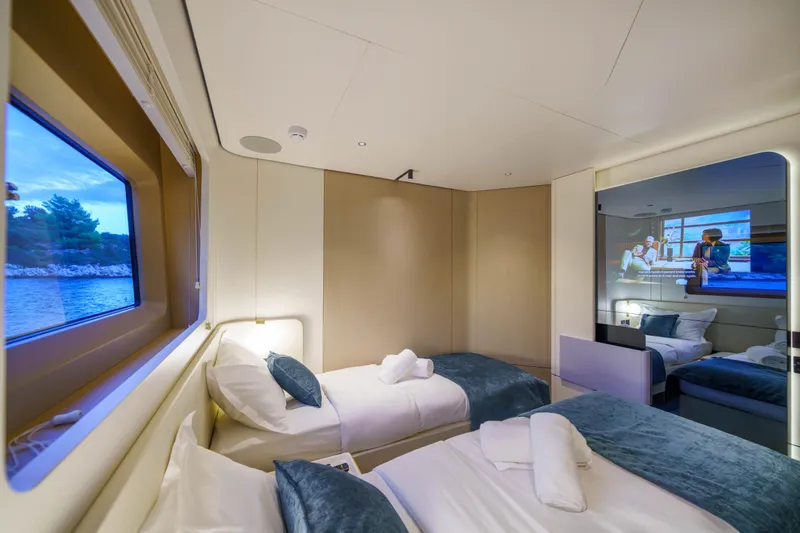 Yacht Photos Pics Luxurious cabin interior of 2025 Azimut Grande 26M yacht with twin beds and scenic window view.