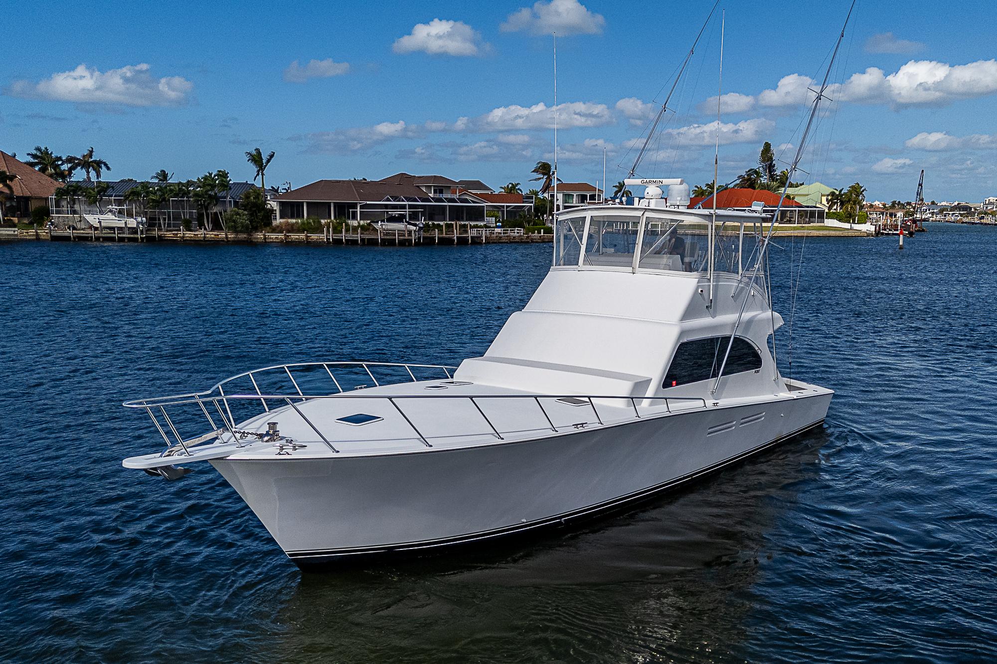 1999 Post 50 Convertible yacht on calm water under blue sky.