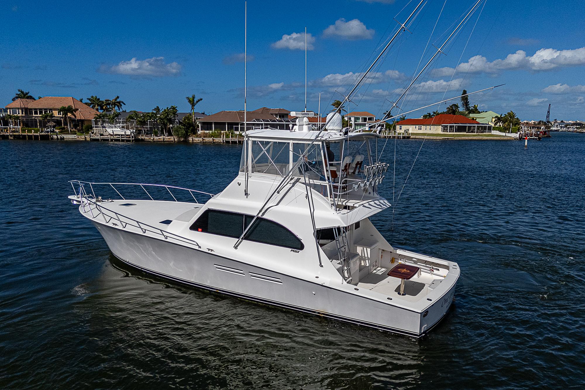 White 1999 Post 50 Convertible yacht cruising on a sunny day.