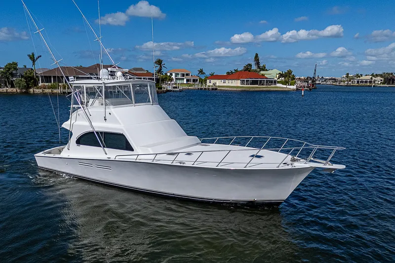 One Of Many Yacht Photos Pics 1999 Post 50 Convertible yacht cruising on a sunny day in a scenic harbor.