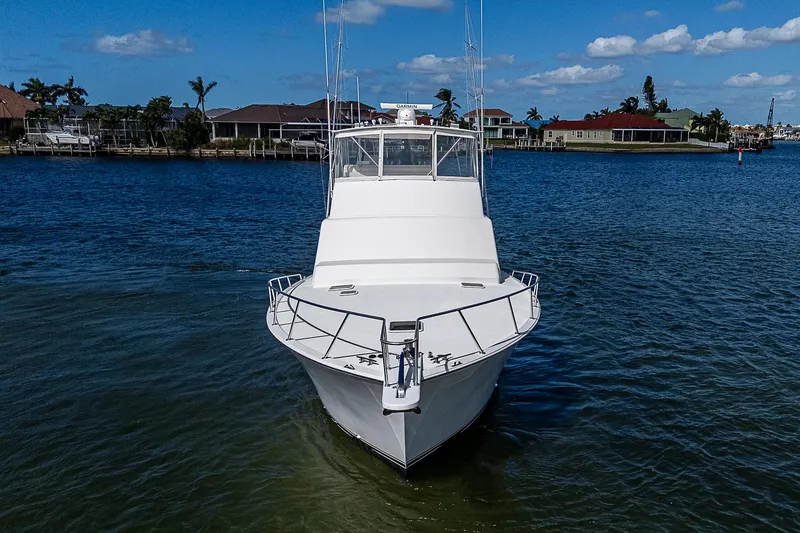 One Of Many Yacht Photos Pics 1999 Post 50 Convertible yacht on calm water, clear sky background.