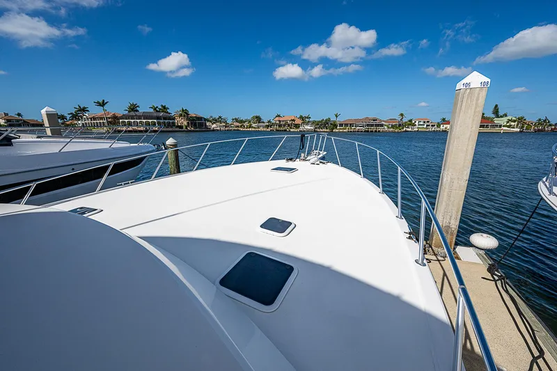 One Of Many Yacht Photos Pics 1999 Post 50 Convertible yacht docked at marina under clear blue sky.