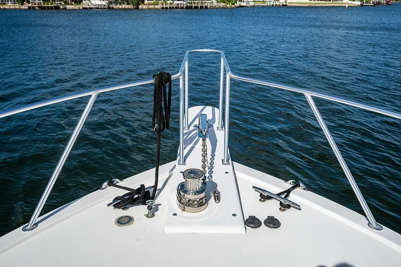 One Of Many Yacht Photos Pics Bow of 1999 Post 50 Convertible boat on calm water.